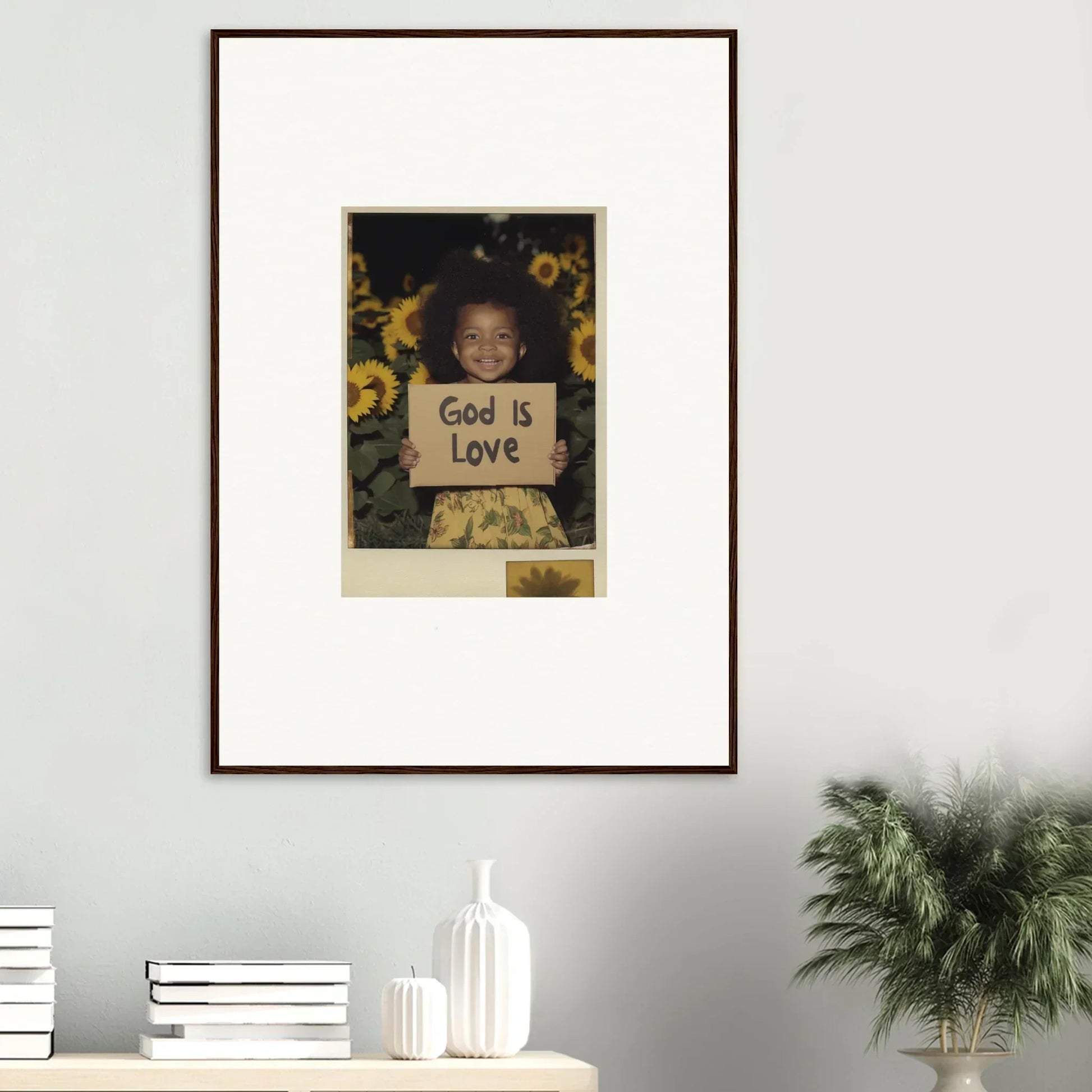 Framed wall art of a child with a God is Love sign and sunflowers for cozy room decoration