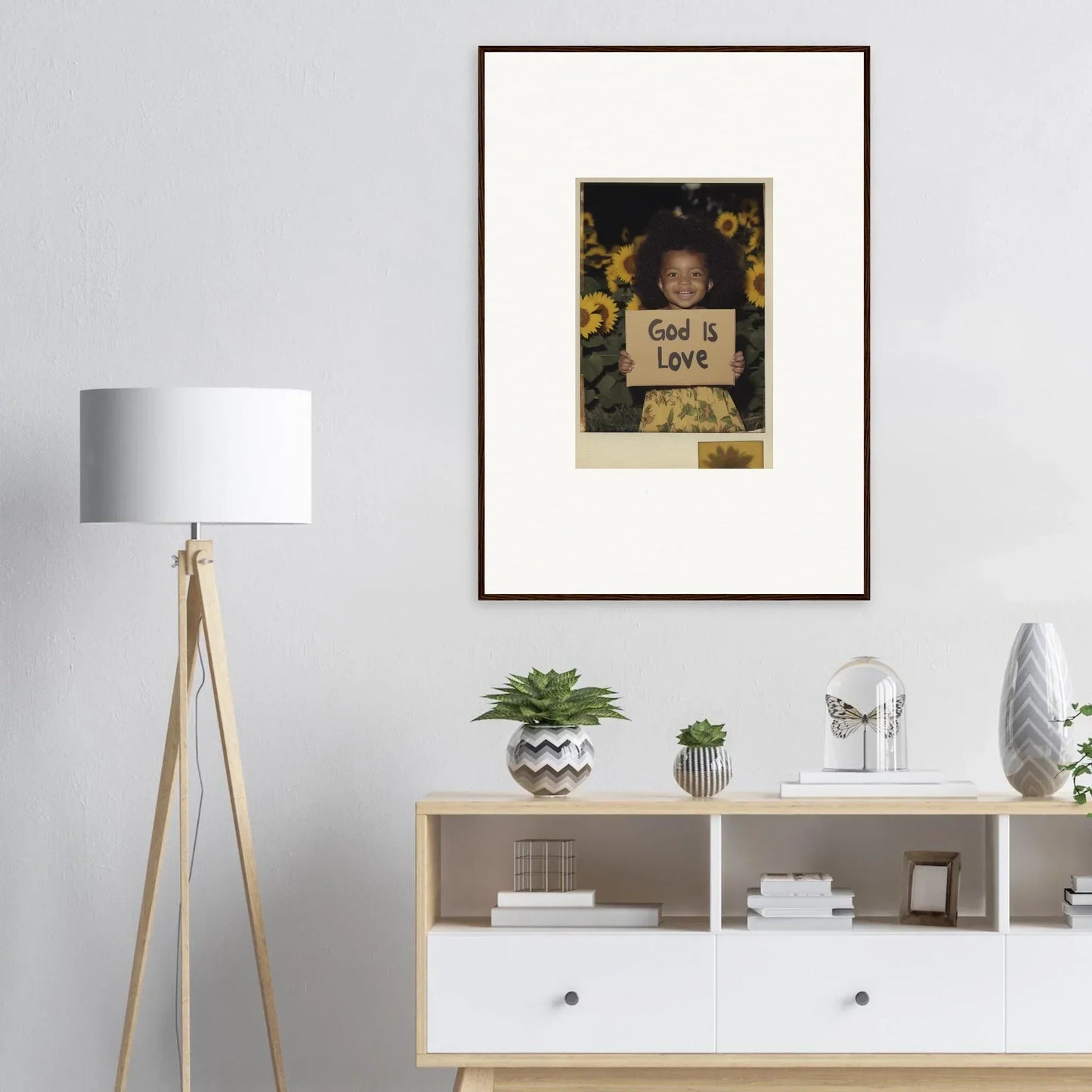 Framed wall art of a child with a God is Love sign, perfect for room decoration