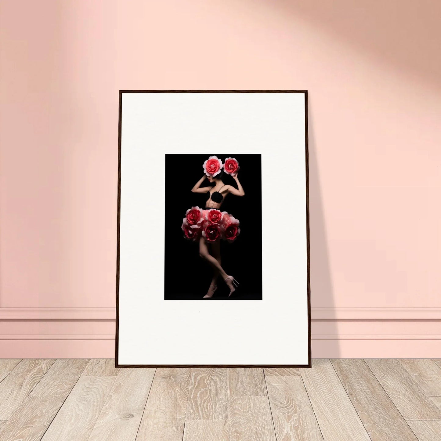 Framed artwork depicting a figure adorned with red floral elements against a dark background.