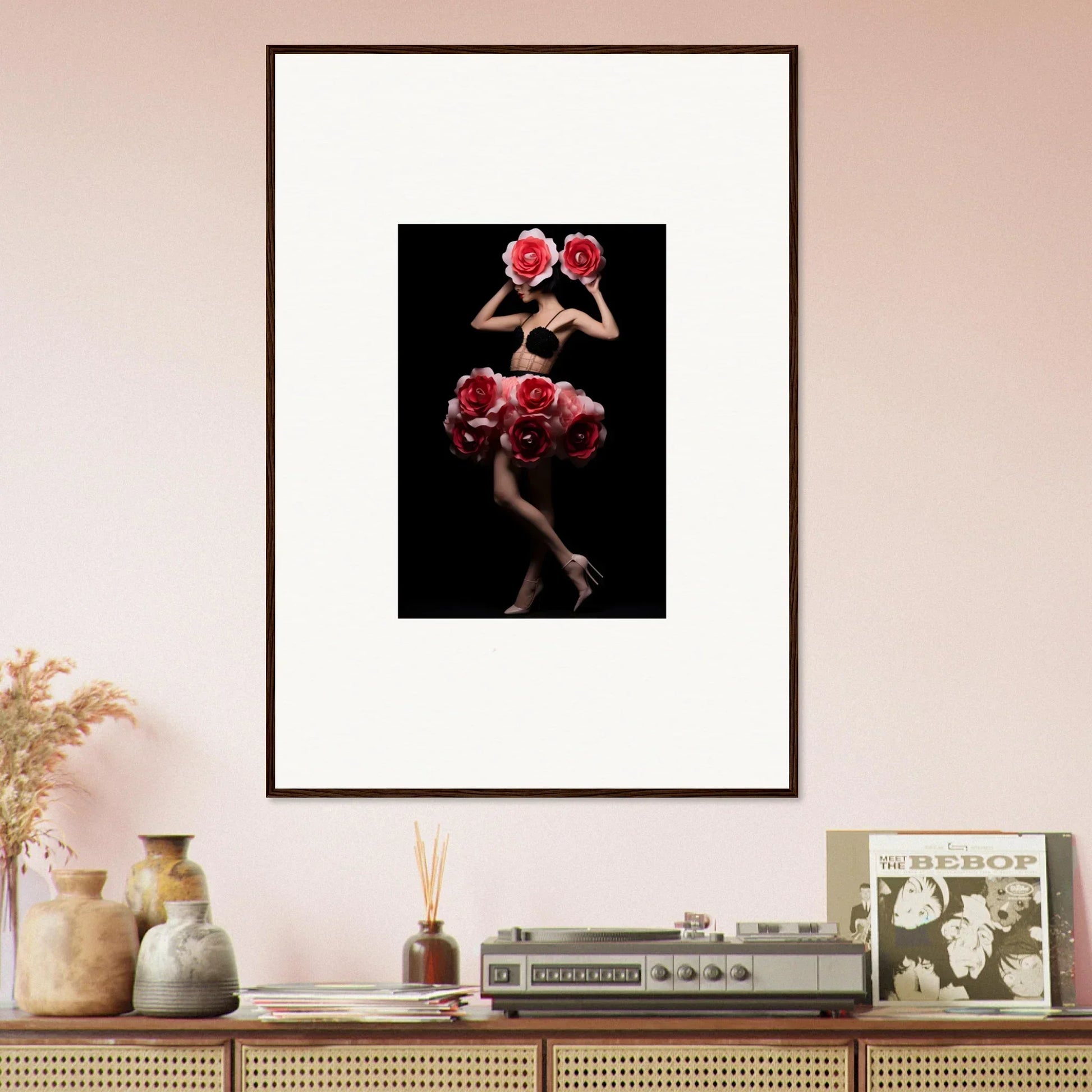 Framed photograph of a figure posing with red roses against a dark background.