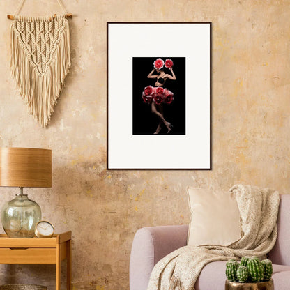 Framed artwork depicting a figure with red floral elements against a dark background.