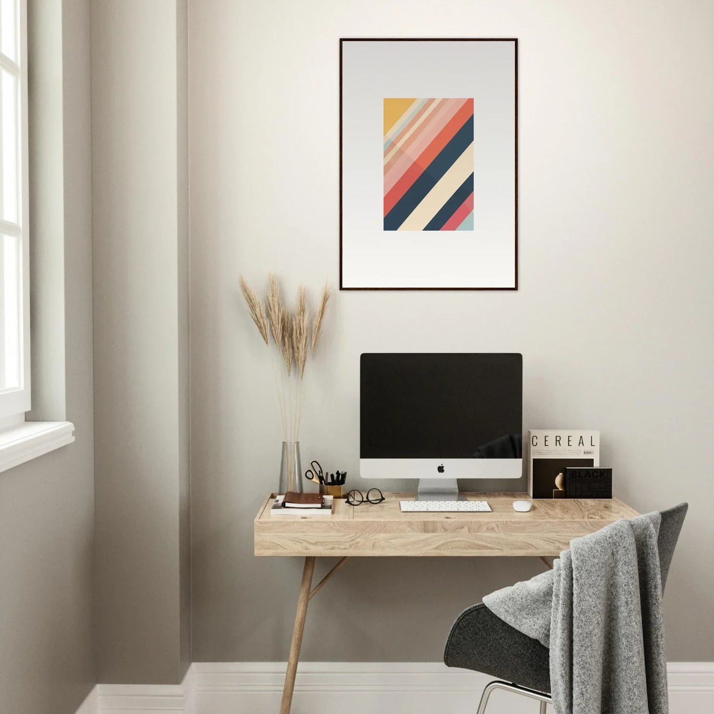 Minimalist wooden desk with a computer and framed wall art for stylish room decor