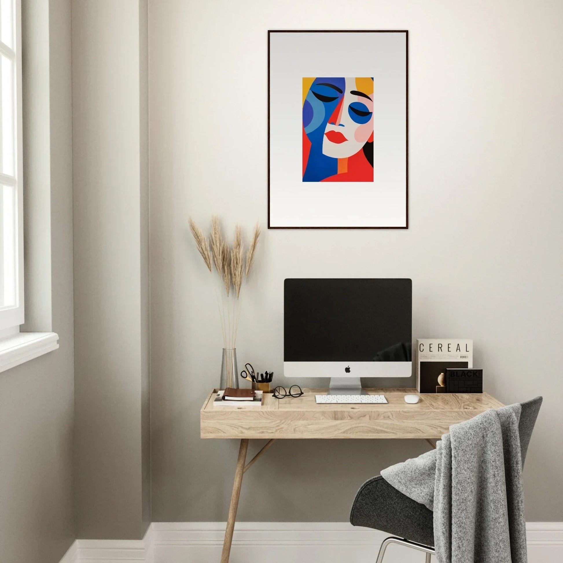 Modern home office with minimalist desk, computer, and Colors Reverie framed wall art