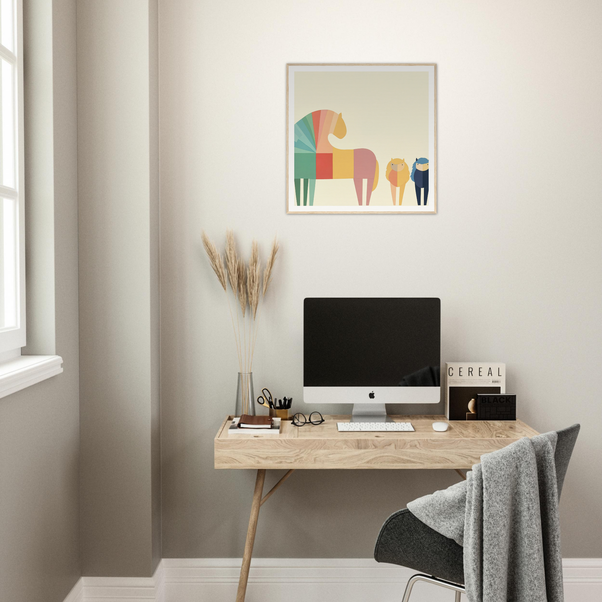 Minimalist wooden desk with iMac and colorful geometric elephant artwork above it