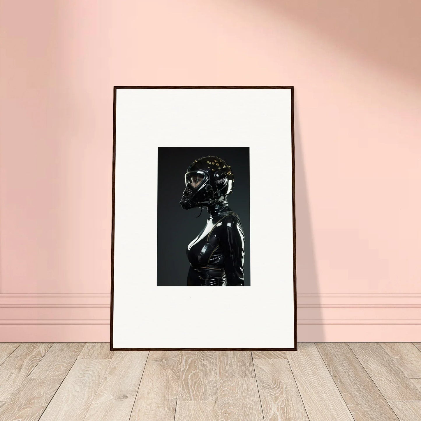 Framed black and white photograph of a figure in a shiny, futuristic outfit with a reflective helmet.