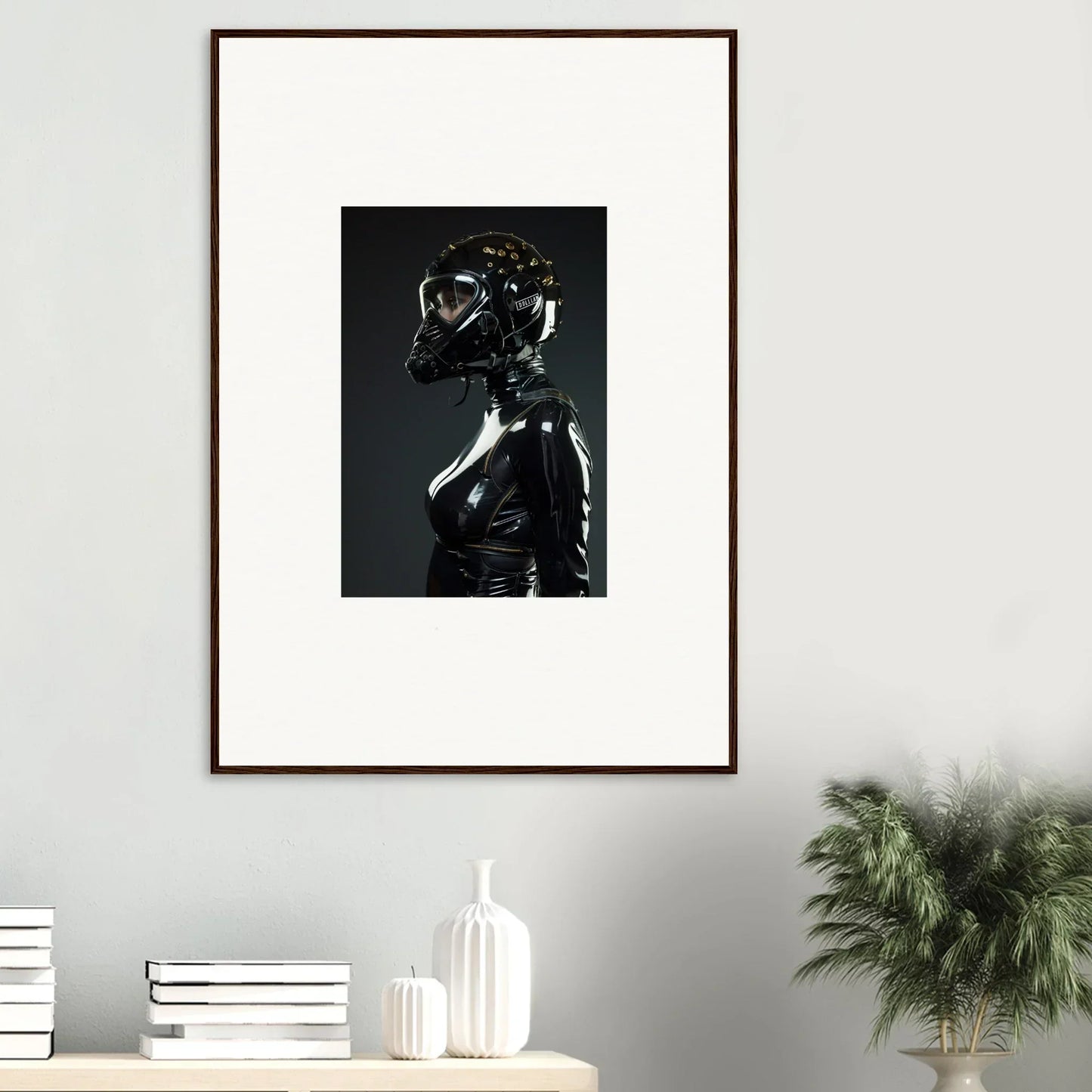 Framed photograph of a figure wearing a shiny black outfit and helmet-like mask.