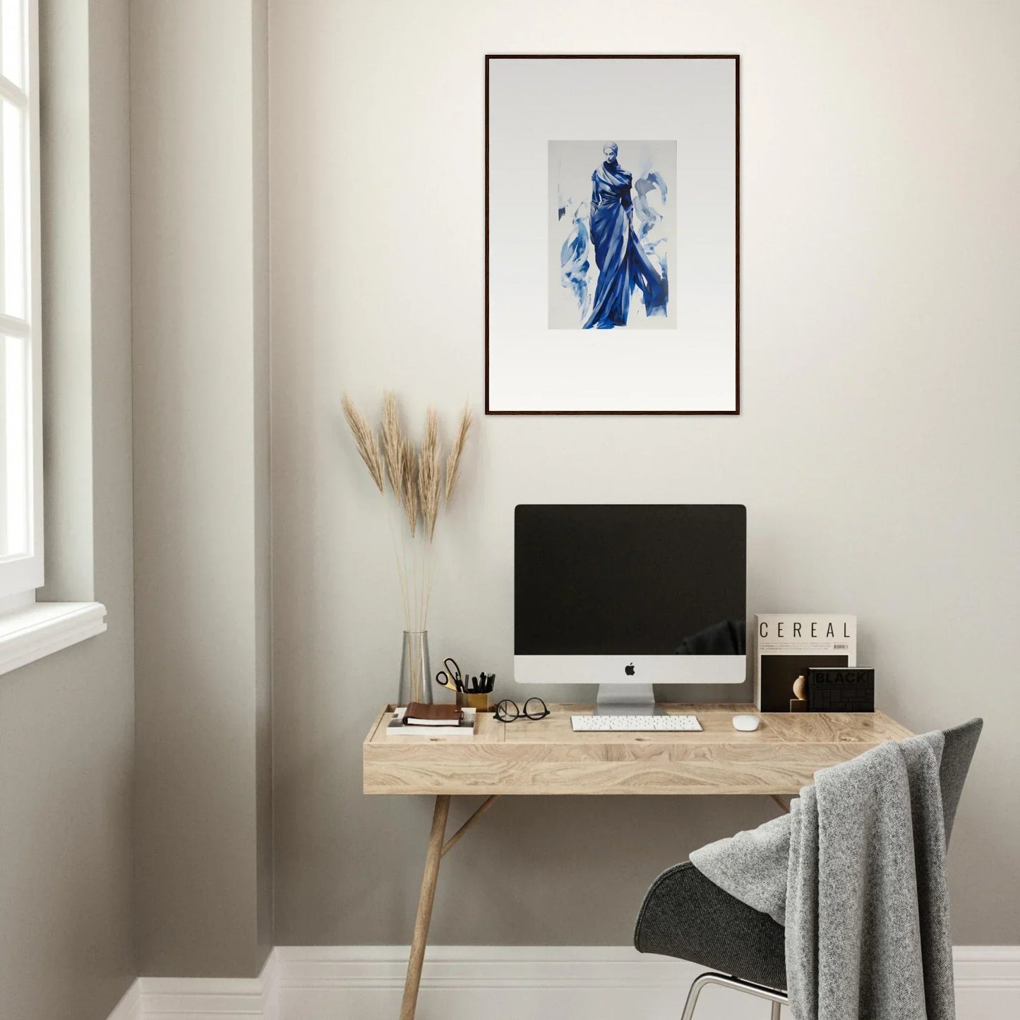 Minimalist wooden desk with iMac and Cosmic Mood Cloaked framed wall art above