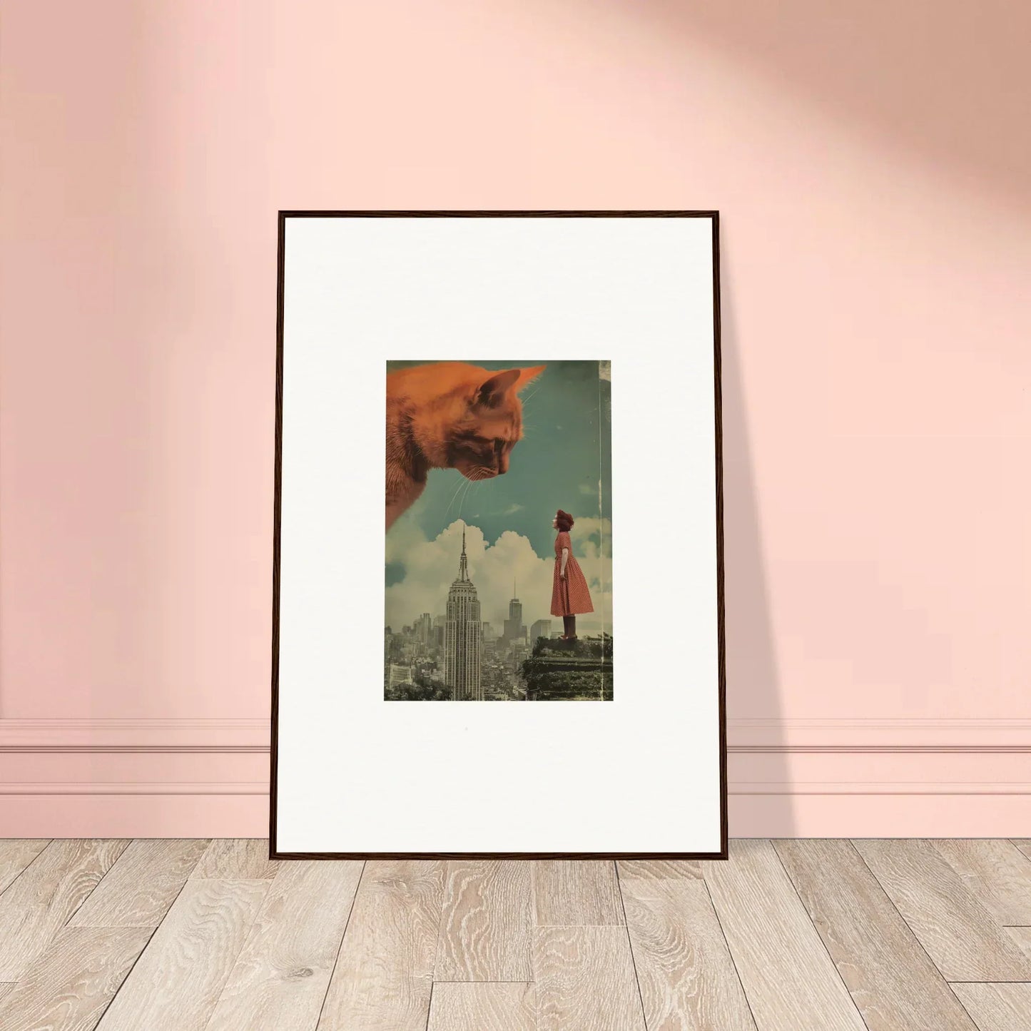 Framed surrealist wall art of a giant cat over a city skyline for whimsical room decor