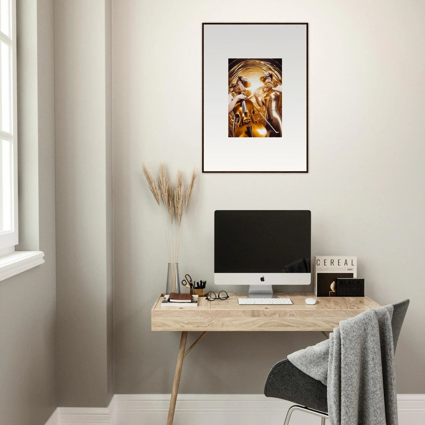 Minimalist home office with wooden desk, computer, and Cosmic Etudes framed wall art