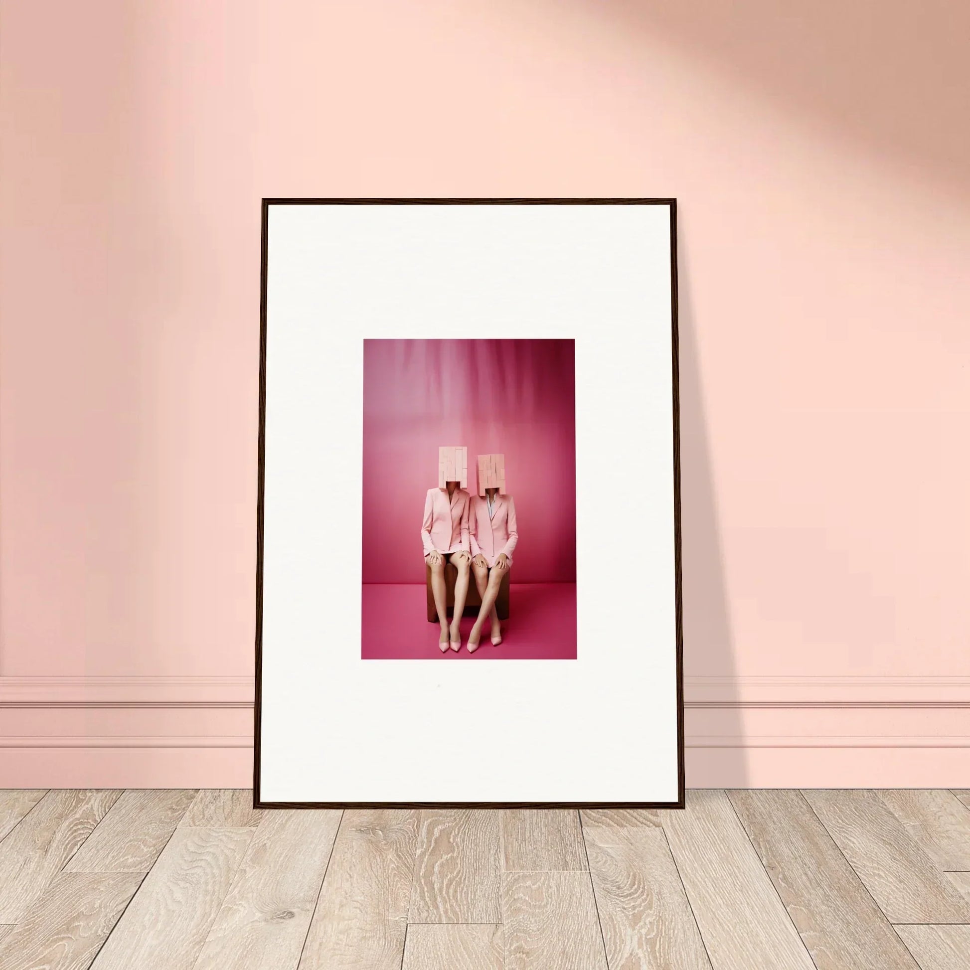 Framed wall art of two figures in white outfits on a pink background for room decoration