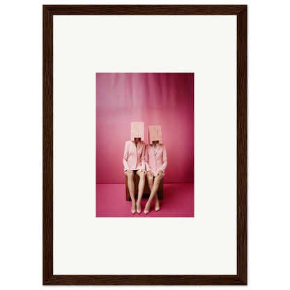 Framed wall art of two figures in pink suits with box heads for fun room decoration