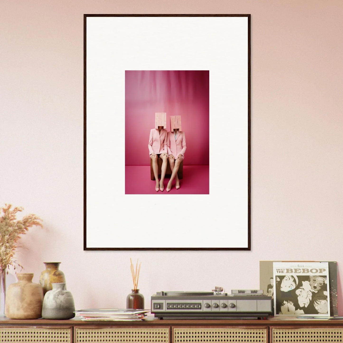 Framed wall art of two figures in pink outfits for stylish room decoration