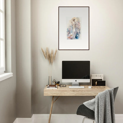 Minimalist home office with wooden desk, computer, and framed wall art amidst bloom