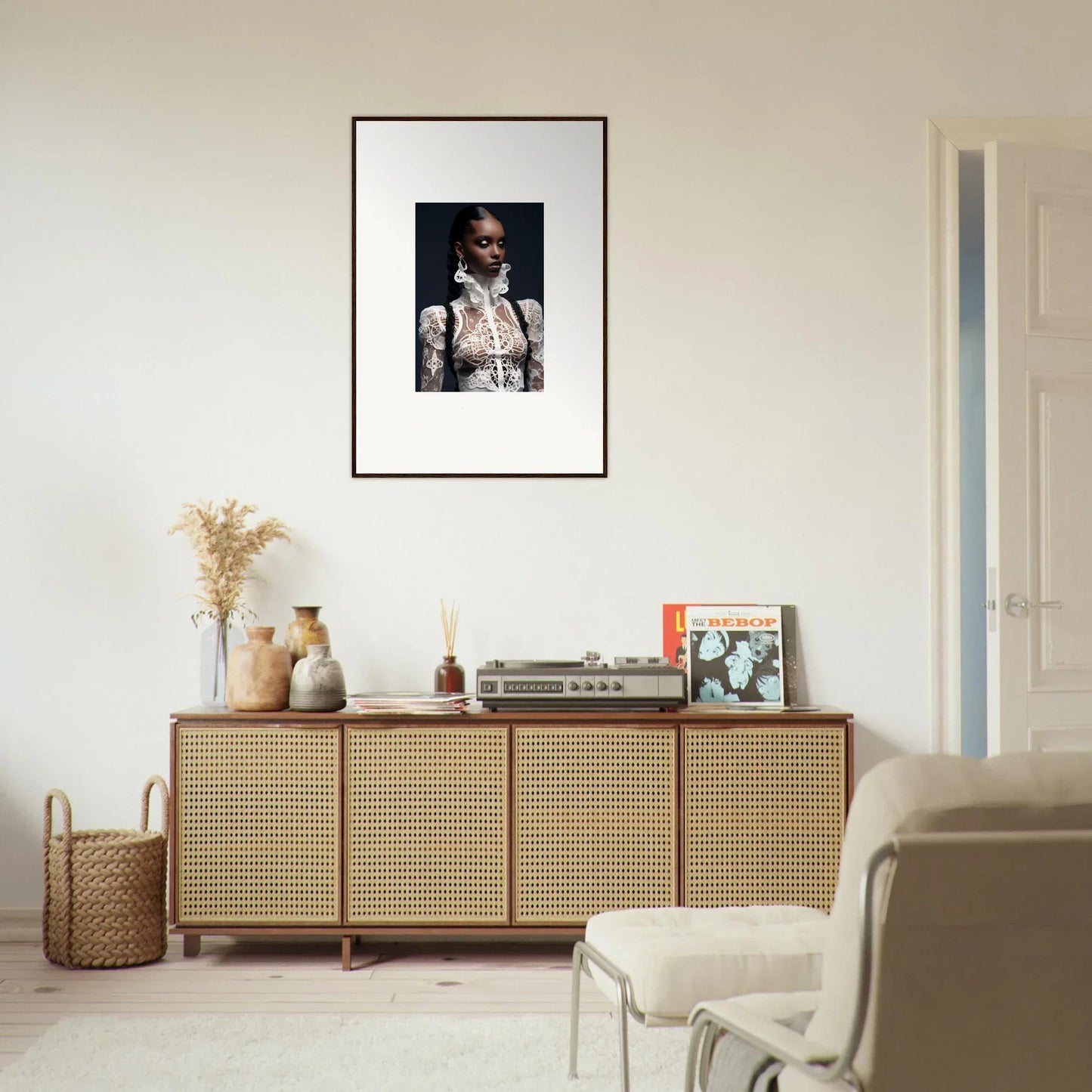 Rattan-fronted wooden sideboard with lace mirage decor and framed wall art above