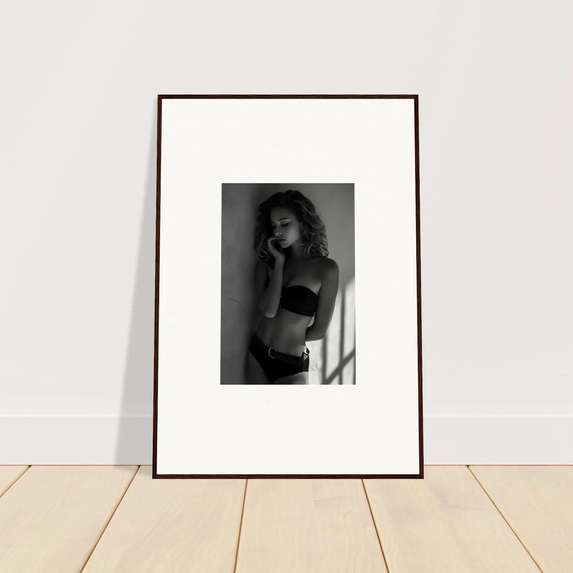 Framed black and white photograph of a person in undergarments.