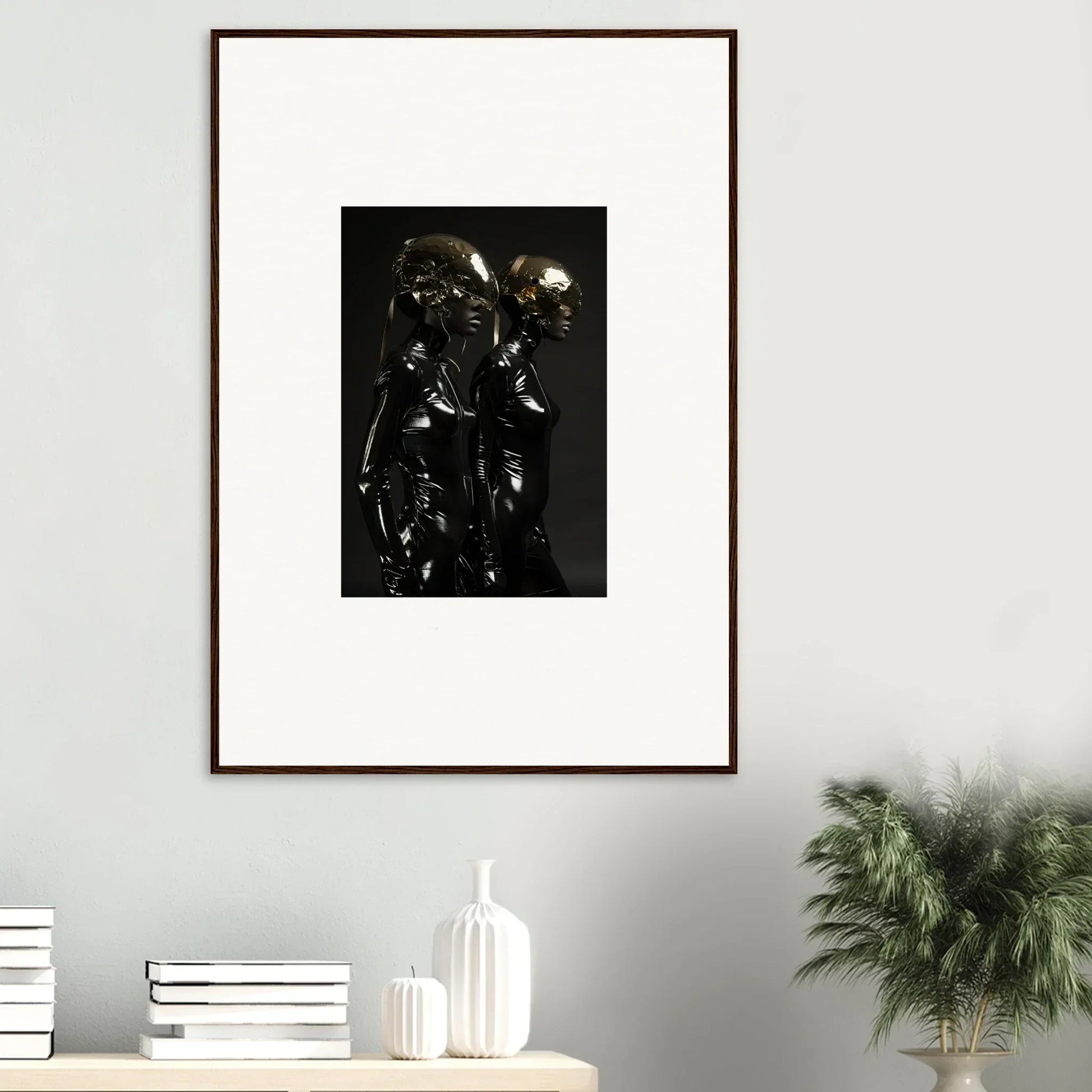 Framed black and white photograph of a metallic, reflective sculpture with abstract humanoid forms.