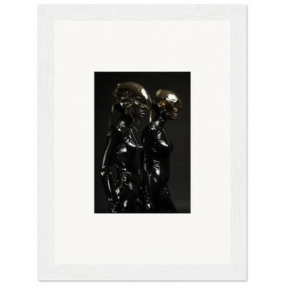 Metallic sculpture depicting two intertwined figures with smooth, reflective surfaces.