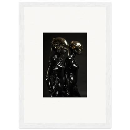 Metallic sculpture of two intertwined figures with reflective surfaces.