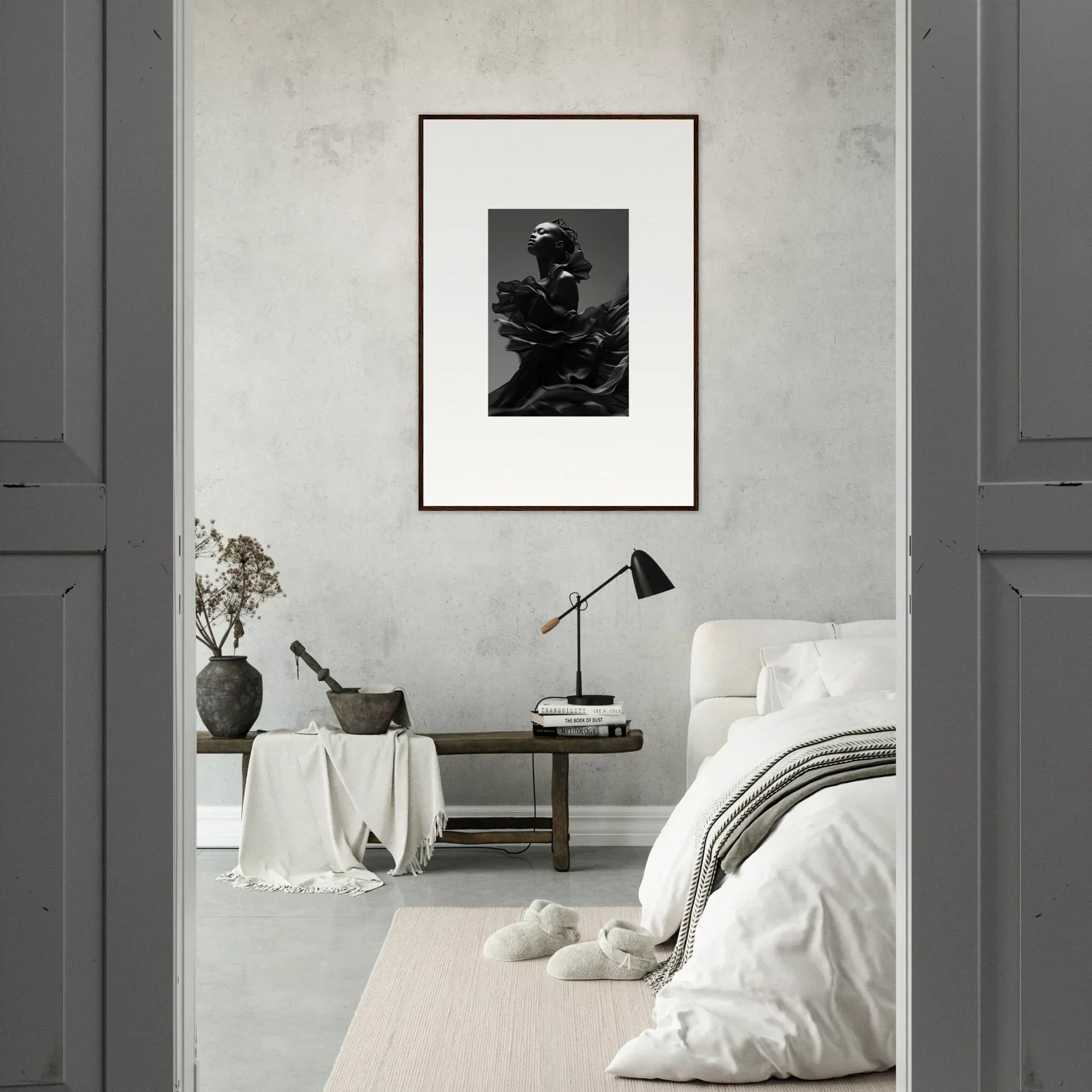 Minimalist bedroom with a framed black and white photograph as the focal point.