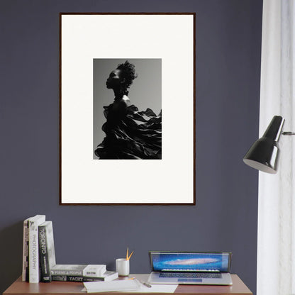 Framed black and white photograph of a silhouetted figure against a mountainous landscape.