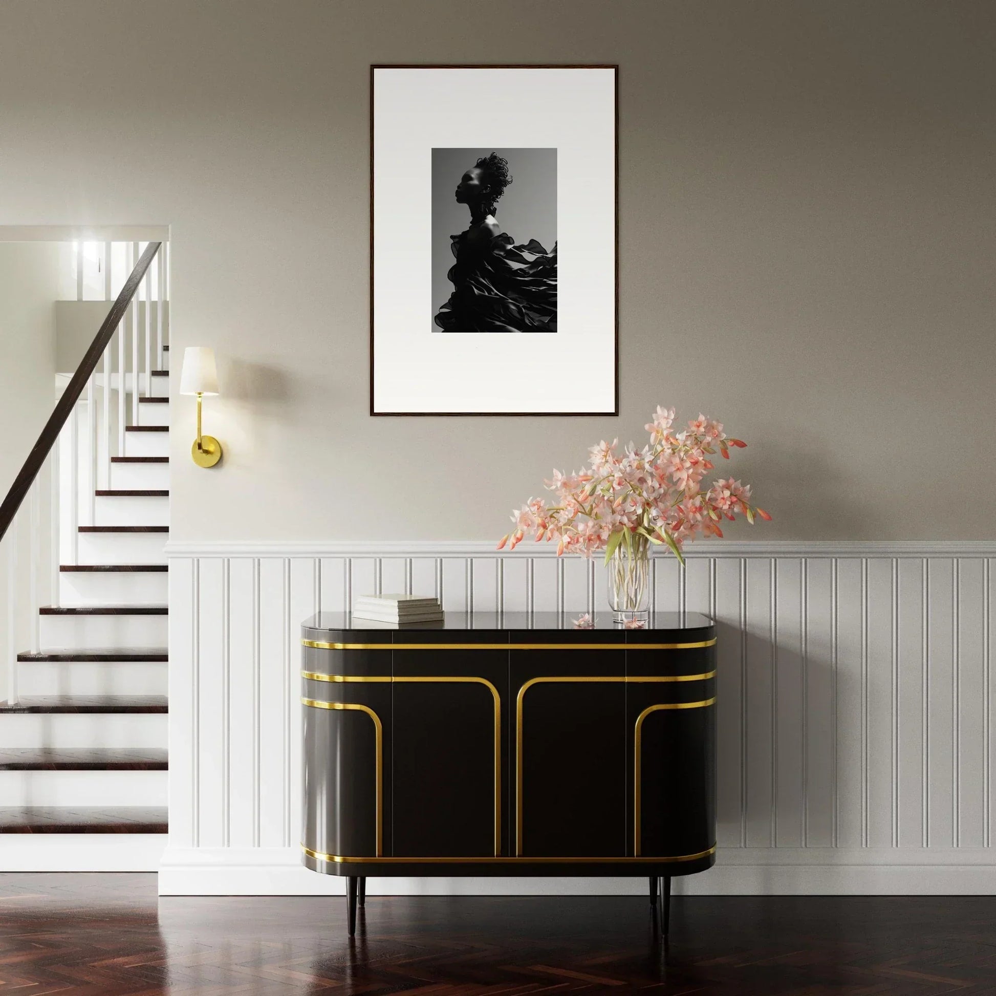 Elegant black and gold sideboard with curved edges beneath a framed black and white photograph.