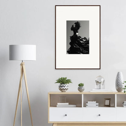 Framed black and white photograph of a silhouetted figure with flowing fabric.