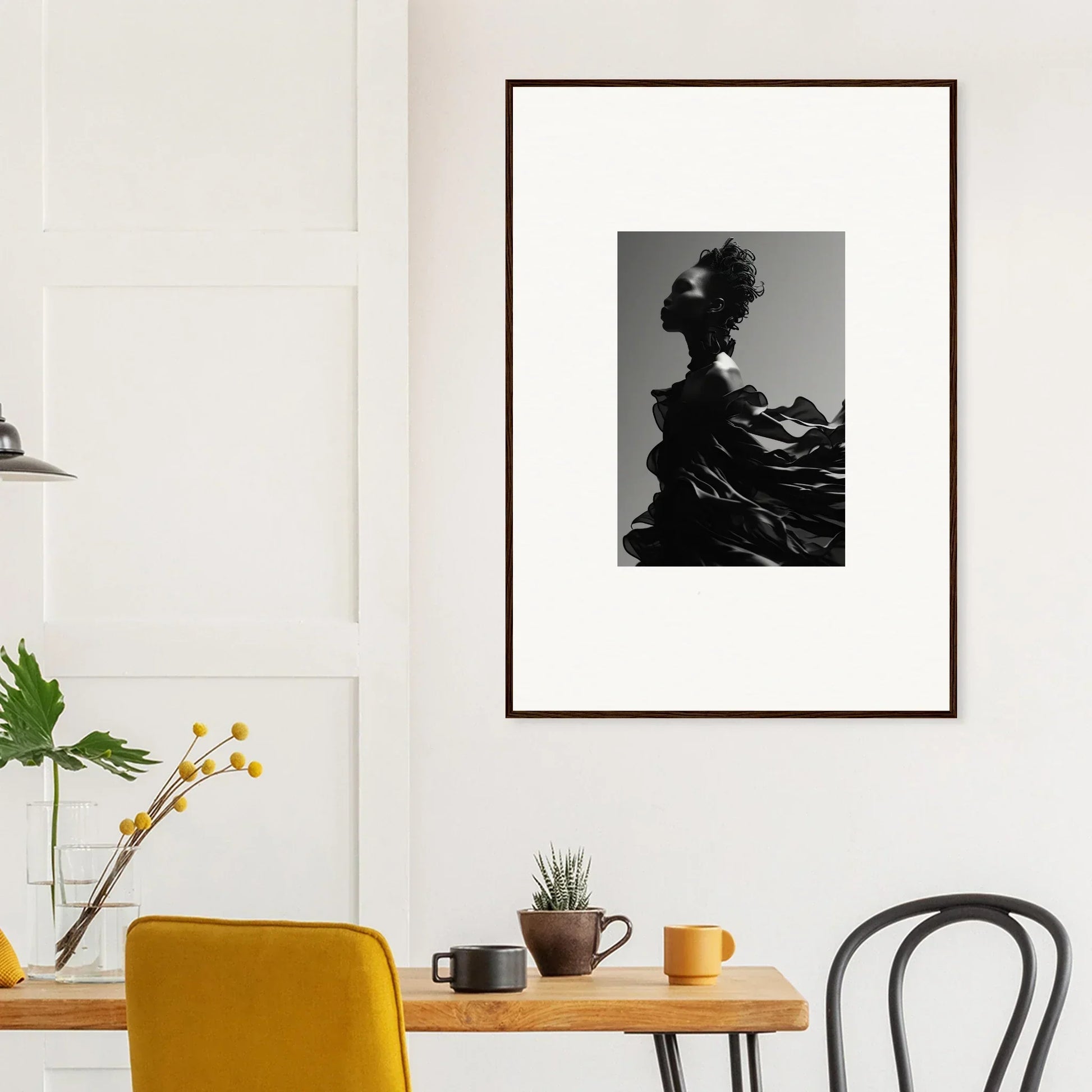 Framed black and white photograph of a silhouetted figure with flowing fabric.