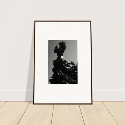 Framed black and white photograph of a silhouetted figure against a mountainous backdrop.