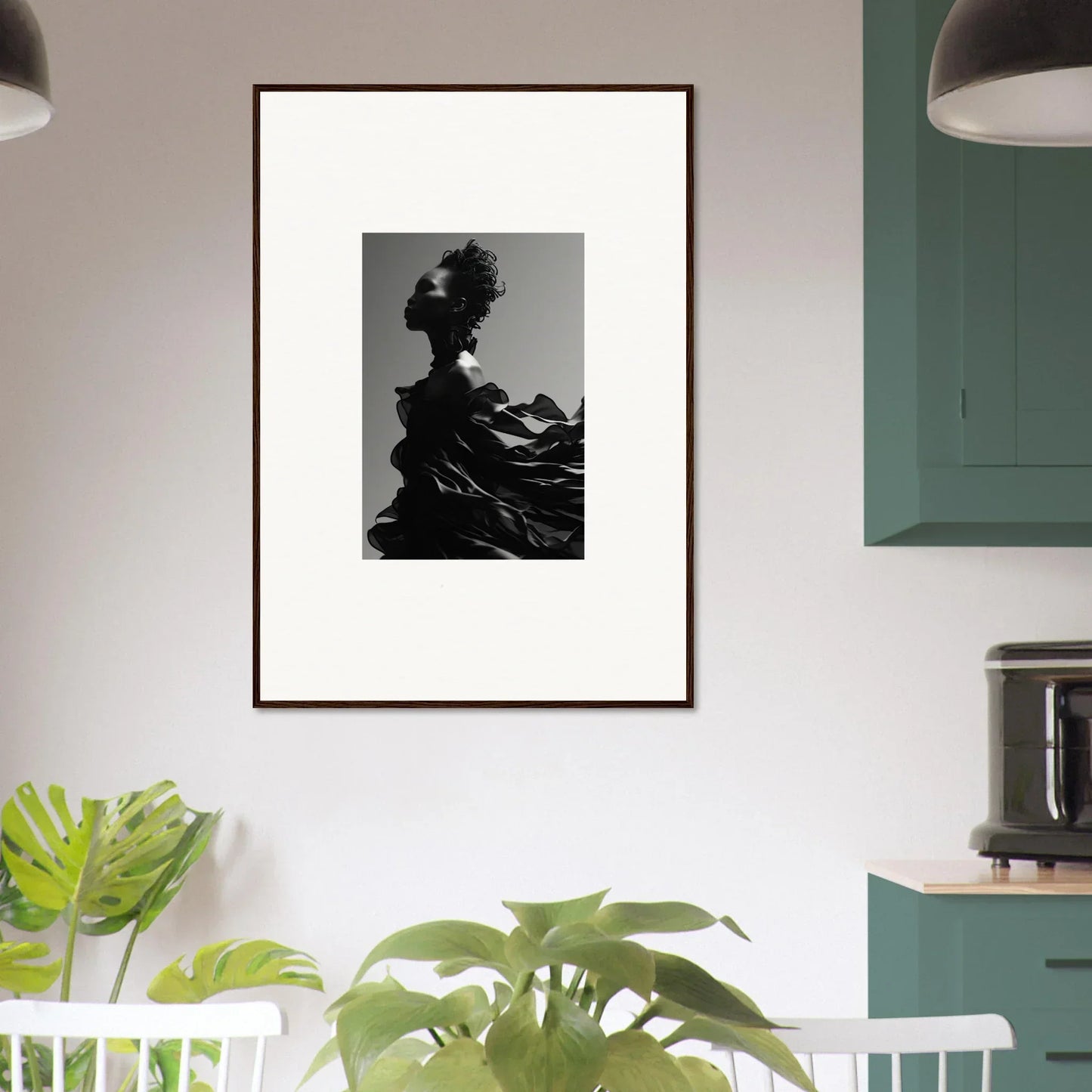 Framed black and white photograph of a silhouetted figure with flowing hair or fabric.