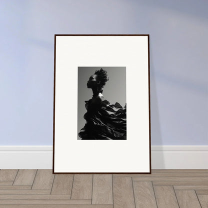 Framed black and white photograph of a silhouetted figure with dramatic, flowing fabric.