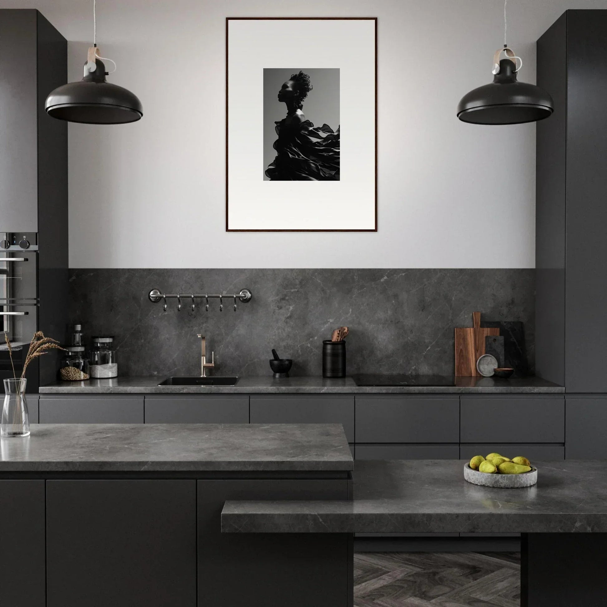 Modern kitchen with dark gray cabinetry and countertops, featuring pendant lights and a framed artwork on the wall.