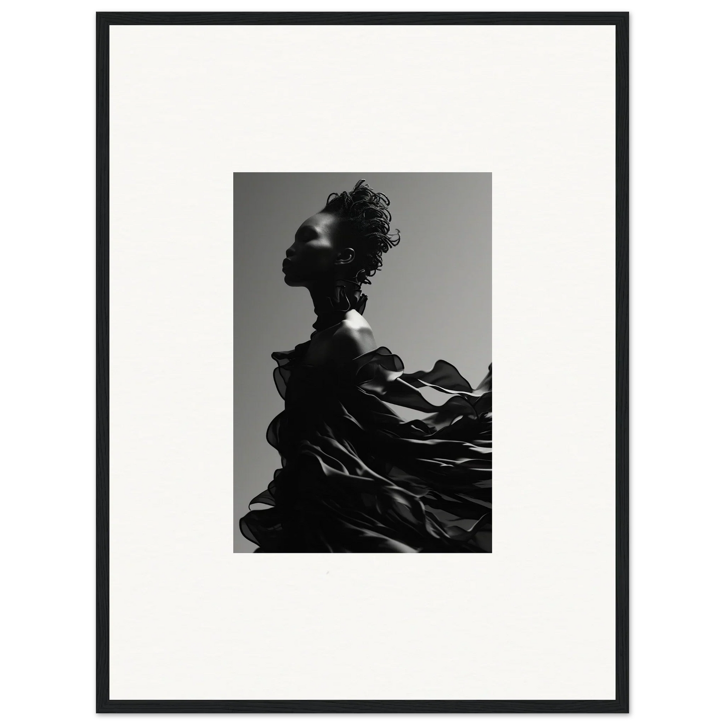 Black and white photograph of a silhouetted figure with dramatic, flowing fabric.