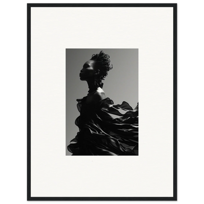 Black and white photograph of a silhouetted figure with dramatic, flowing fabric.