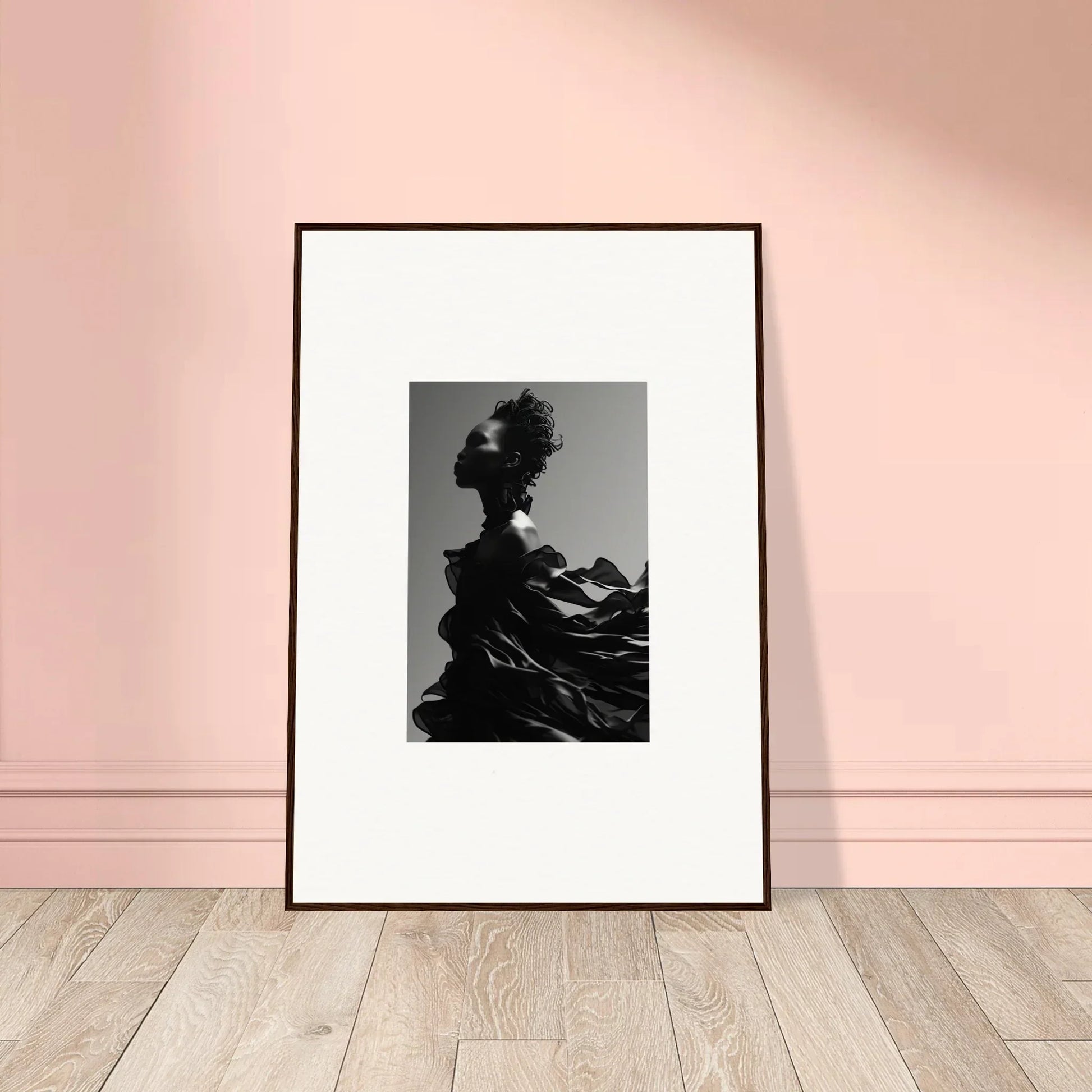 Framed black and white photograph of a silhouetted figure with an elaborate headdress.