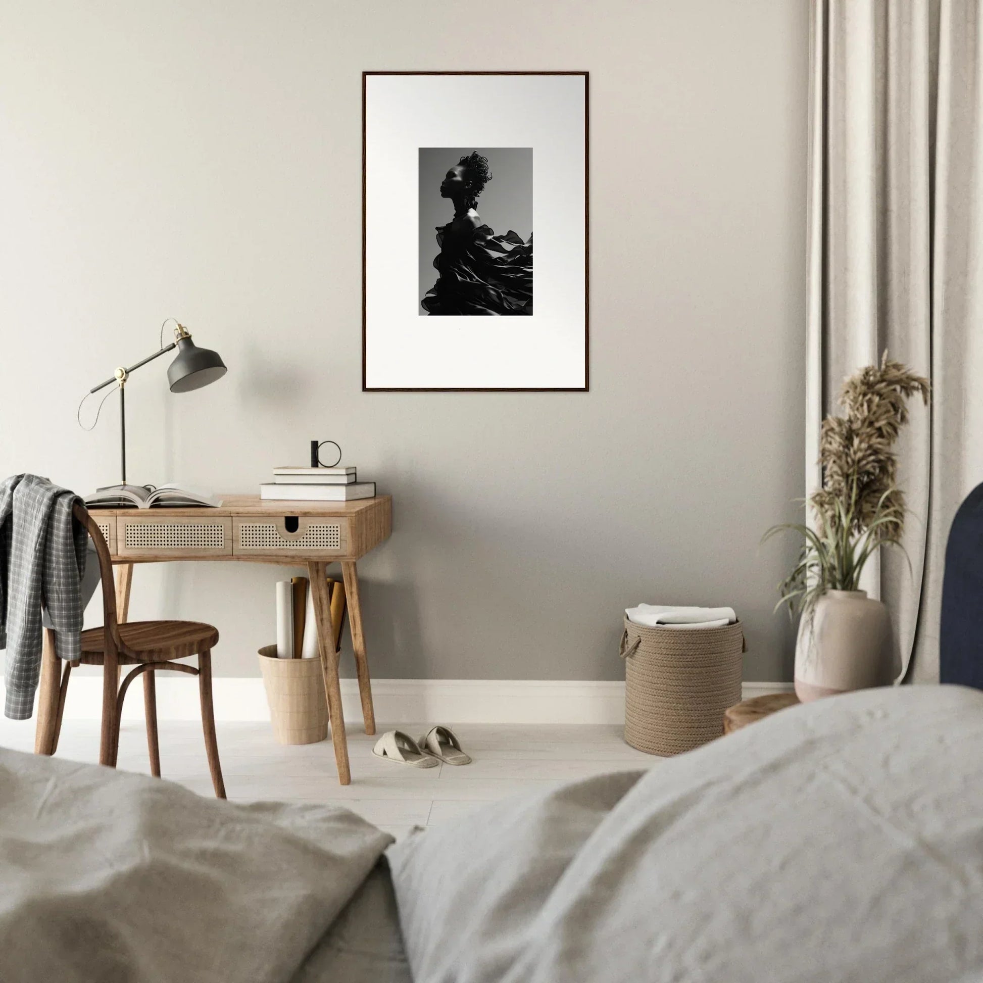 Framed black and white photograph of a silhouetted figure hanging on a wall.