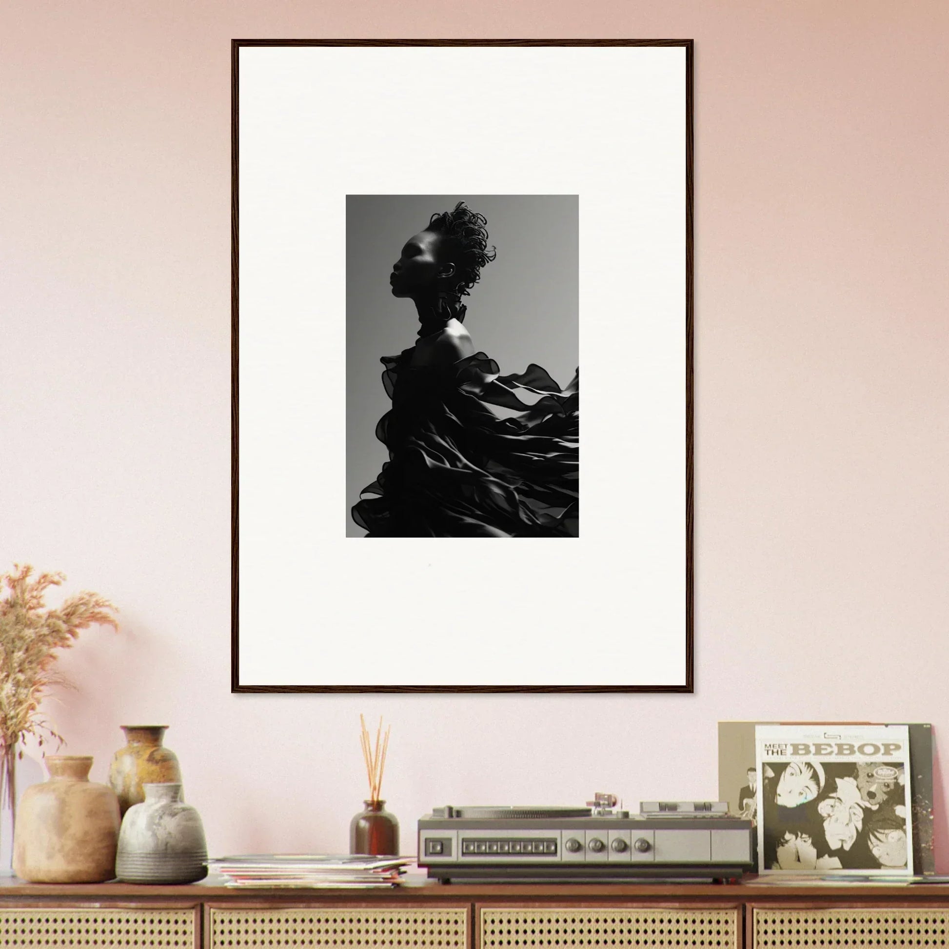 Framed black and white photograph of a silhouetted figure with an elaborate headdress.