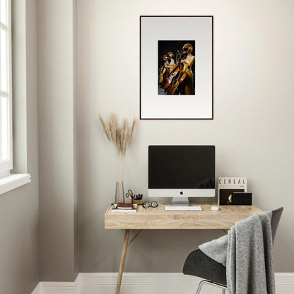 Minimalist wooden desk with computer monitor and amber crescendo framed wall art