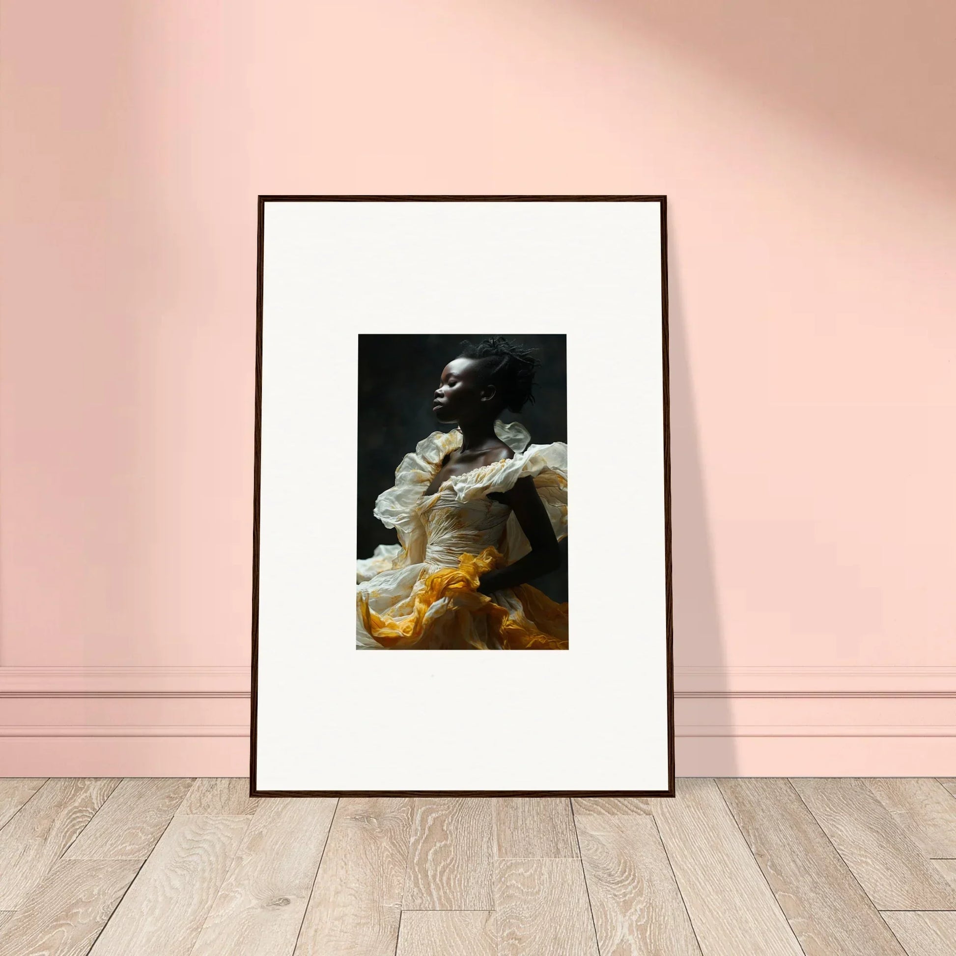 Framed wall art of a person in dramatic light with eclipsed fluttering yellow fabric