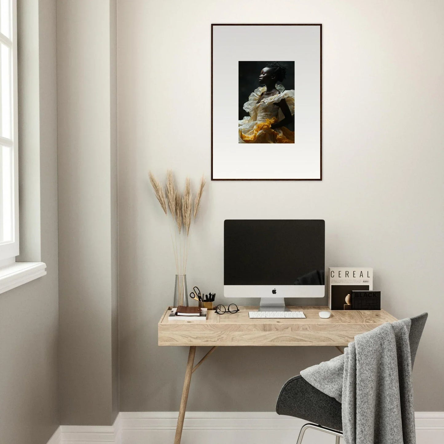 Minimalist wooden desk with computer and framed wall art for elegant room decor