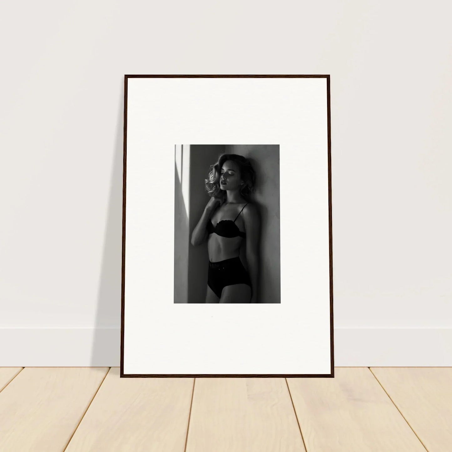 Framed black and white photograph of a woman in lingerie.