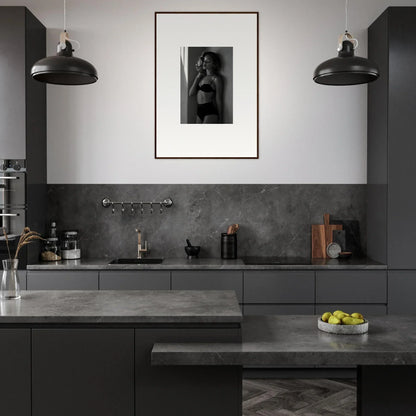 Modern kitchen with dark gray cabinetry and countertops.