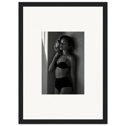 Black and white photograph of a woman in lingerie standing near a window.