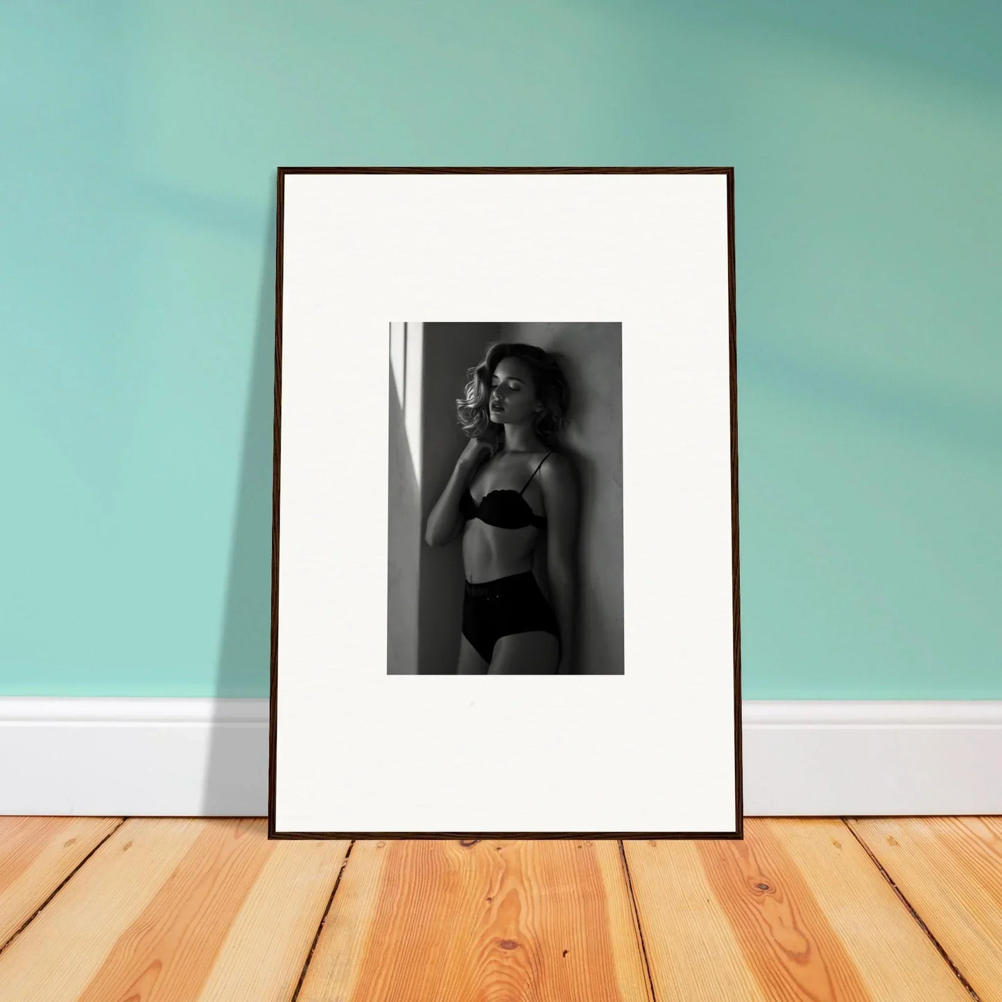 Framed black and white photograph of a woman in undergarments.