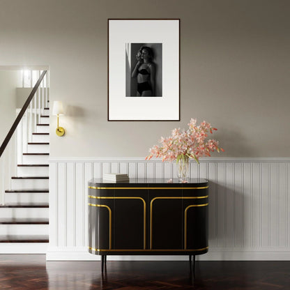 Elegant black and gold sideboard with curved edges and sleek design.