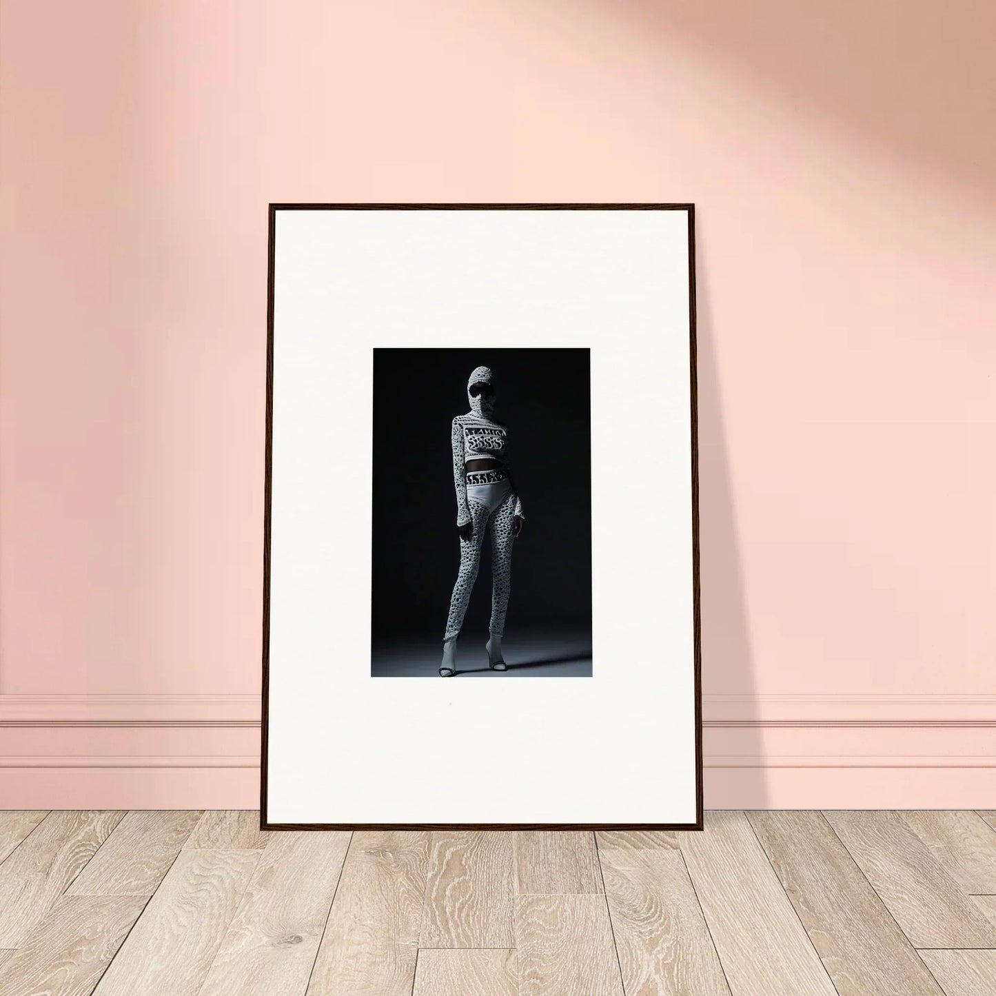 Framed black and white photograph of a stylish person for chic mirage room decor