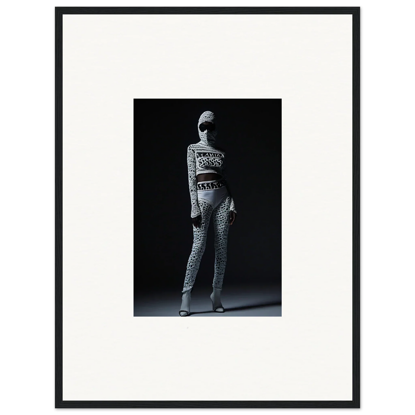 Black and white photo of person in patterned outfit for chic mirage framed wall art