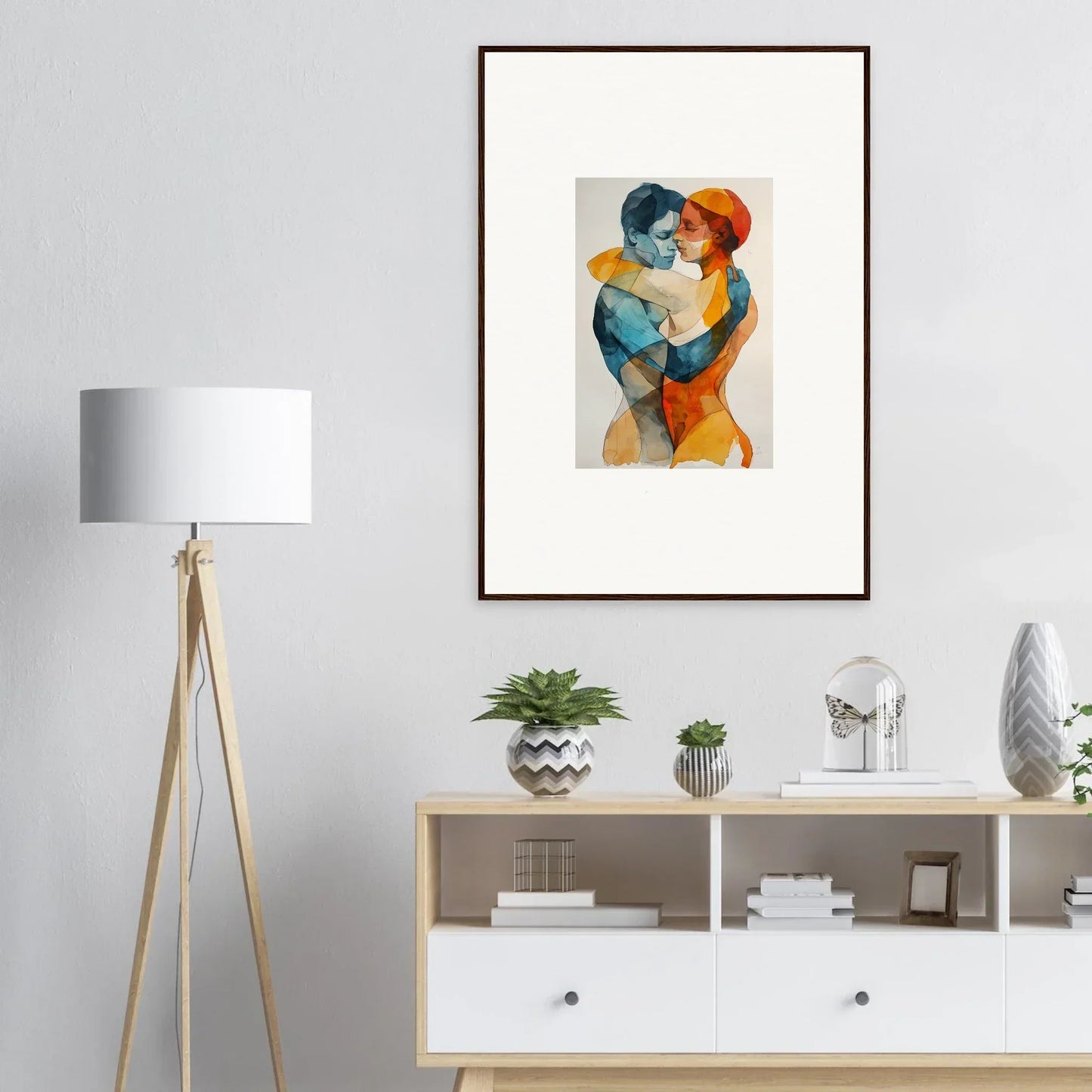 Framed wall art of embracing figures in vibrant colors for stylish room decor