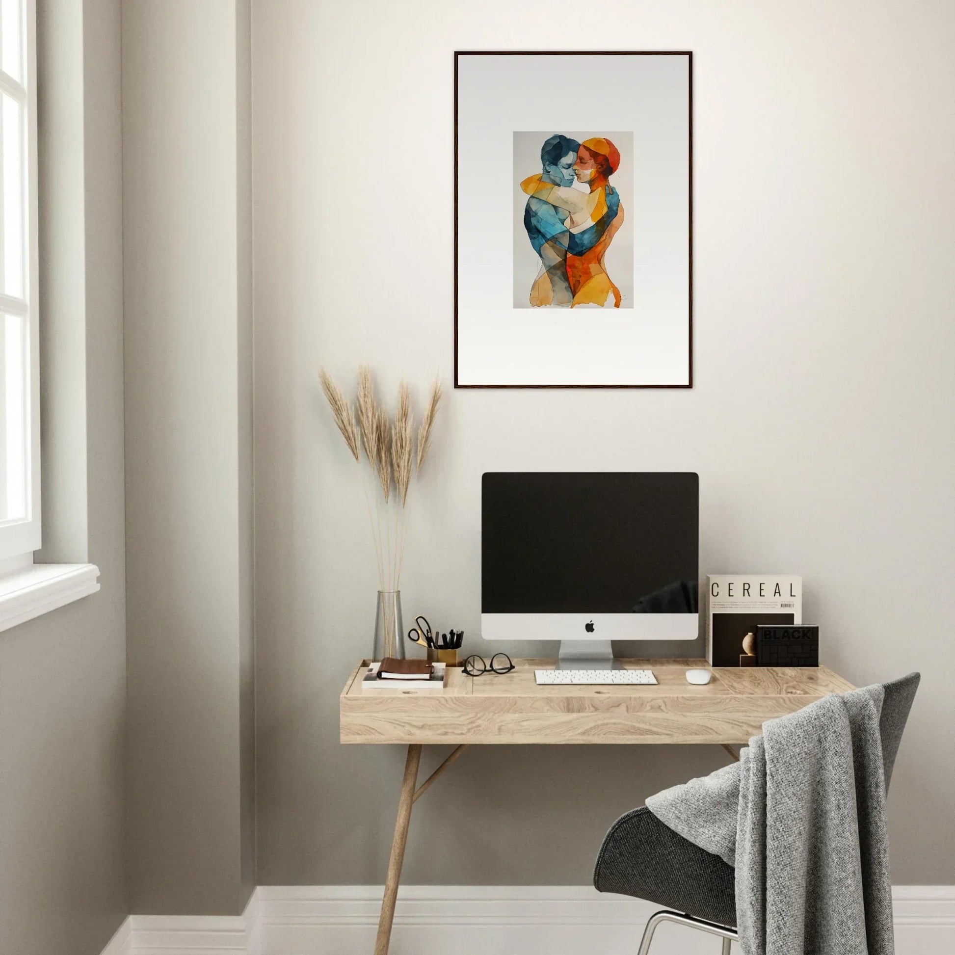 Minimalist home office with wooden desk, computer, and framed wall art for Aqua Souls Tangent