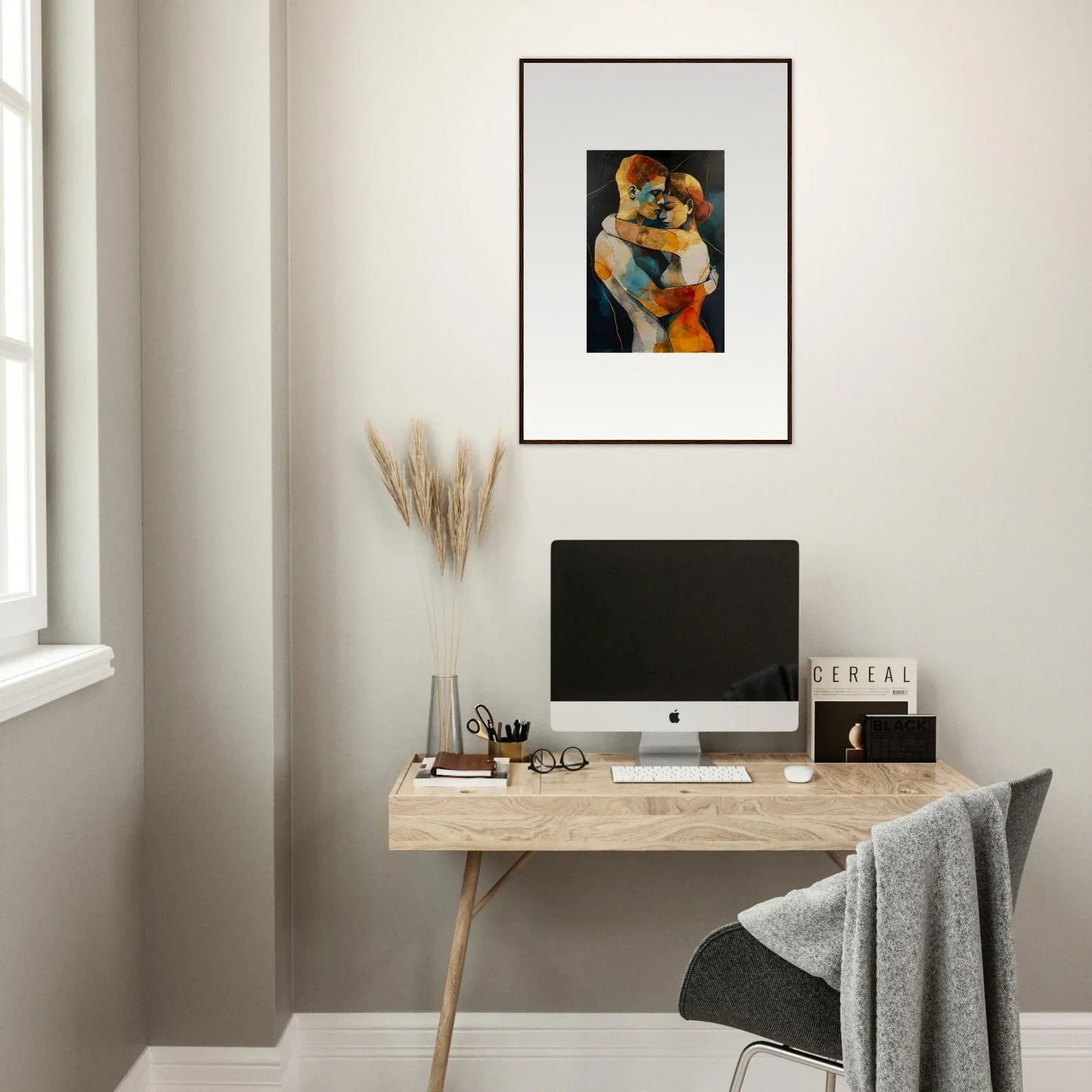 Minimalist home office with wooden desk, computer, and Framed Wall Art Bondscreen Embrace