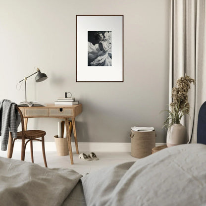 Minimalist bedroom featuring a wooden desk, chair, and framed wall art for dreams blossom